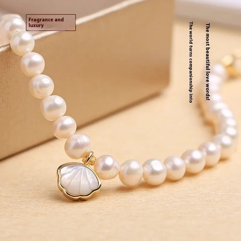 Women's freshwater pearl bracelet with fan-shaped shell design on 16cm elastic or extension chain