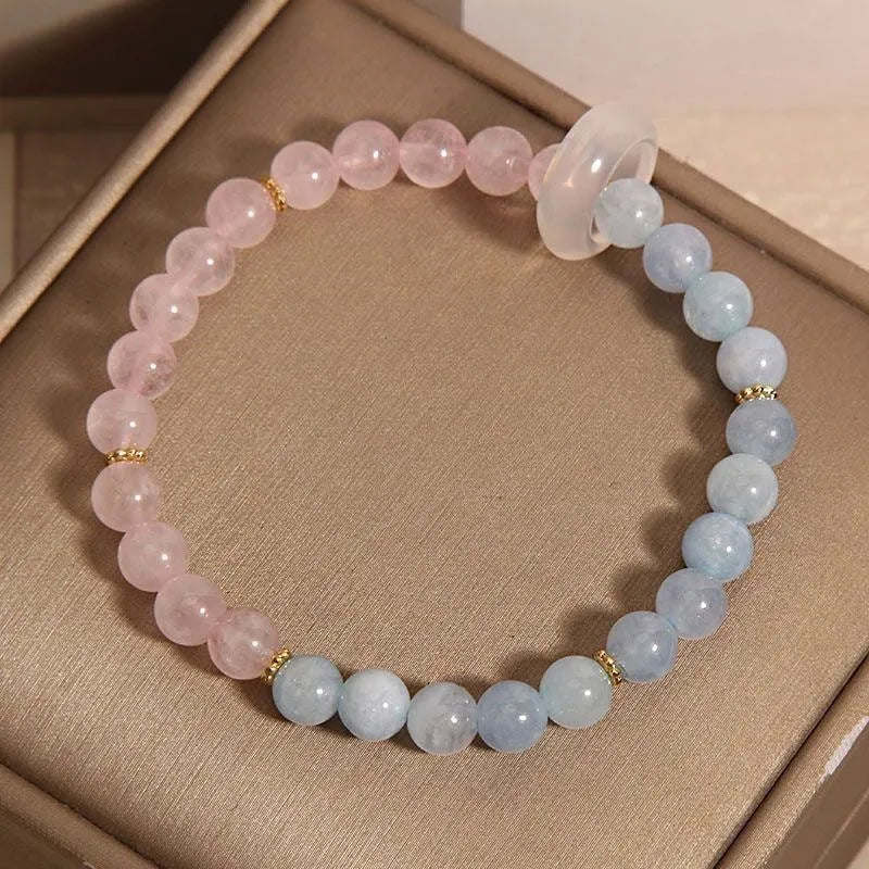 Women's aquamarine crystal bracelet with round geometric beads in mixed materials including natural pink crystal and imitation pearl