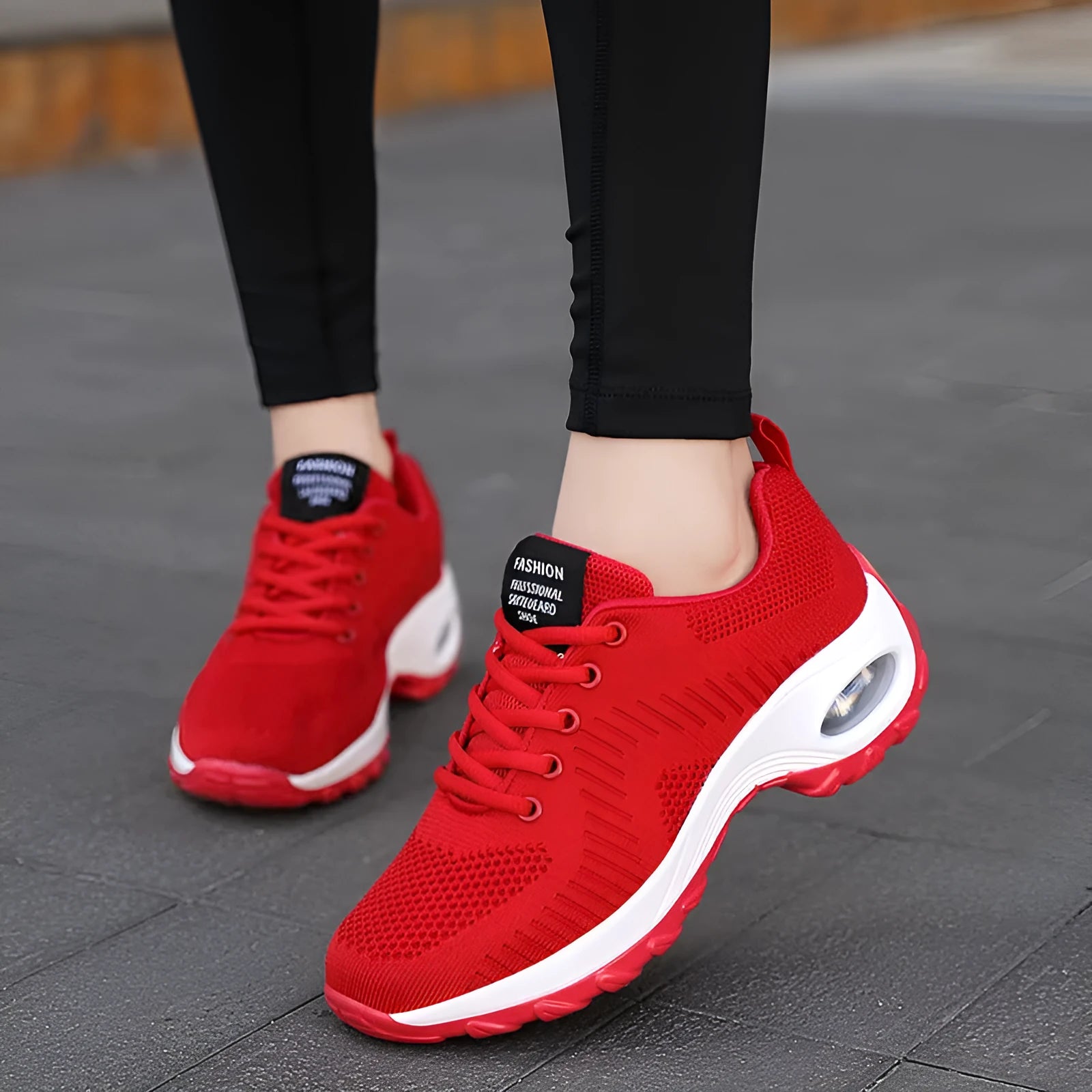 Red women's mesh sneakers with round toe and front lace-up design showing low top silhouette
