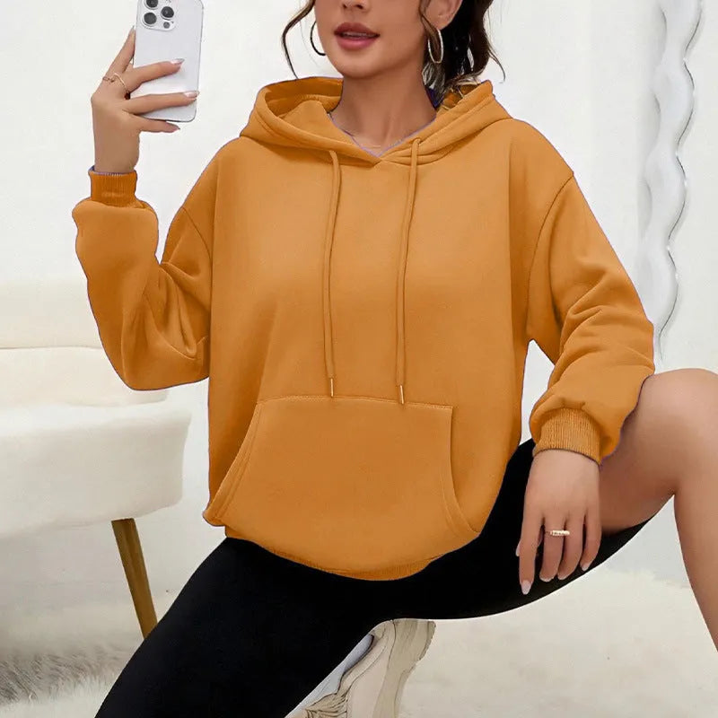 Women's loose black drawstring pocket sweatshirt with long sleeves and a front kangaroo pouch.