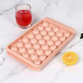 Blue silicone ice cube tray with lid showing 33 round grids for large ice cubes