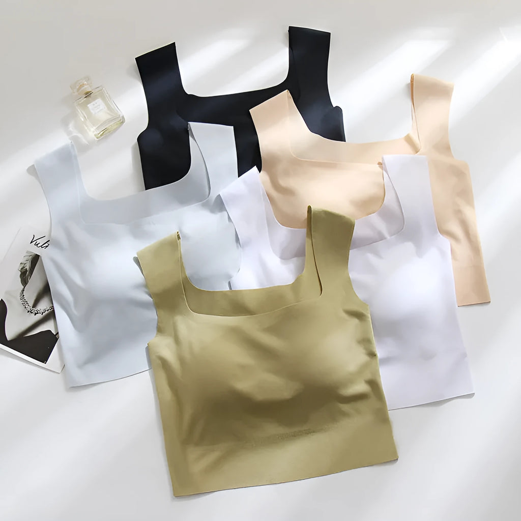 Women's non-marking sling vest in light blue, showing seamless design and abdominal length.