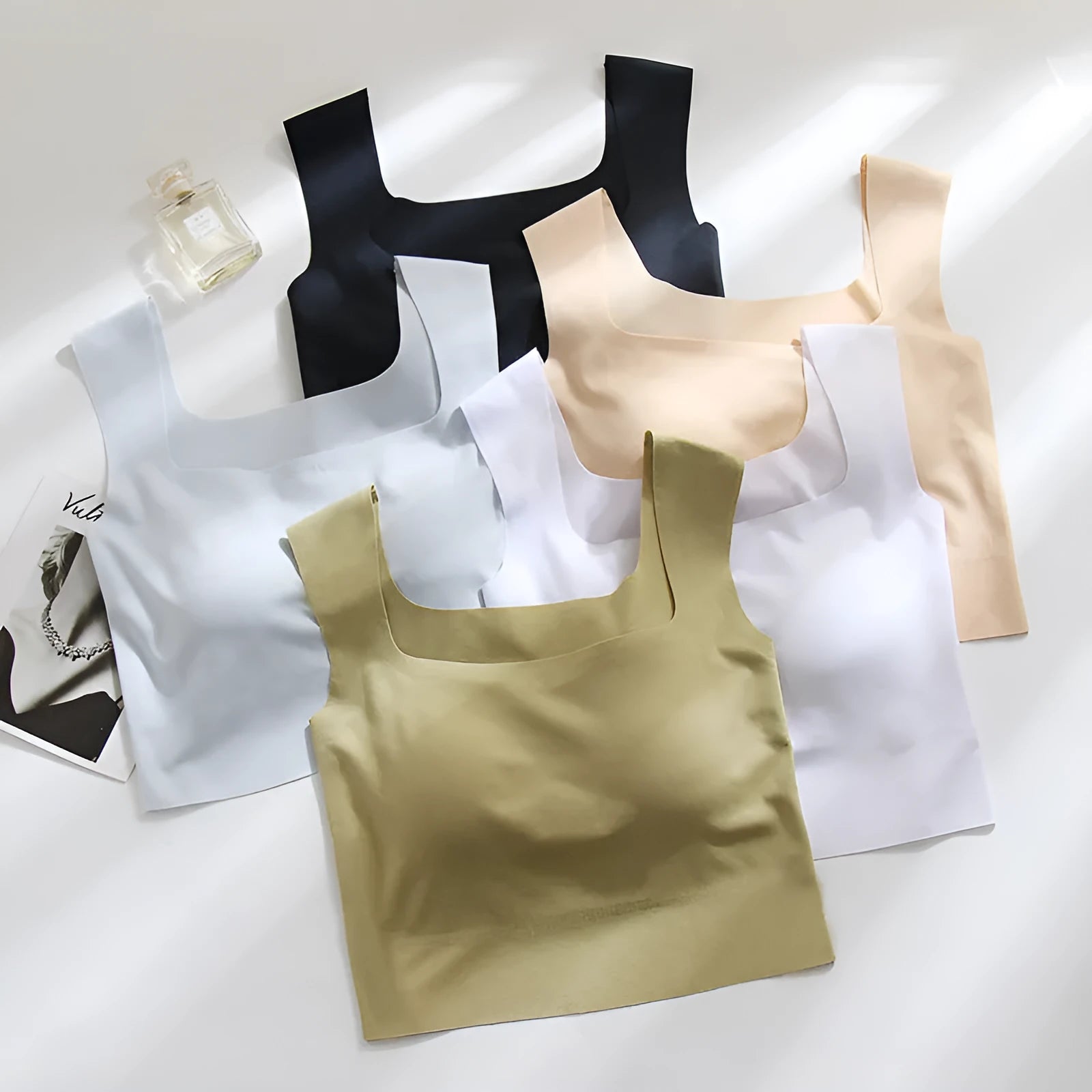 Women's non-marking sling vest in light blue, showing seamless design and abdominal length.