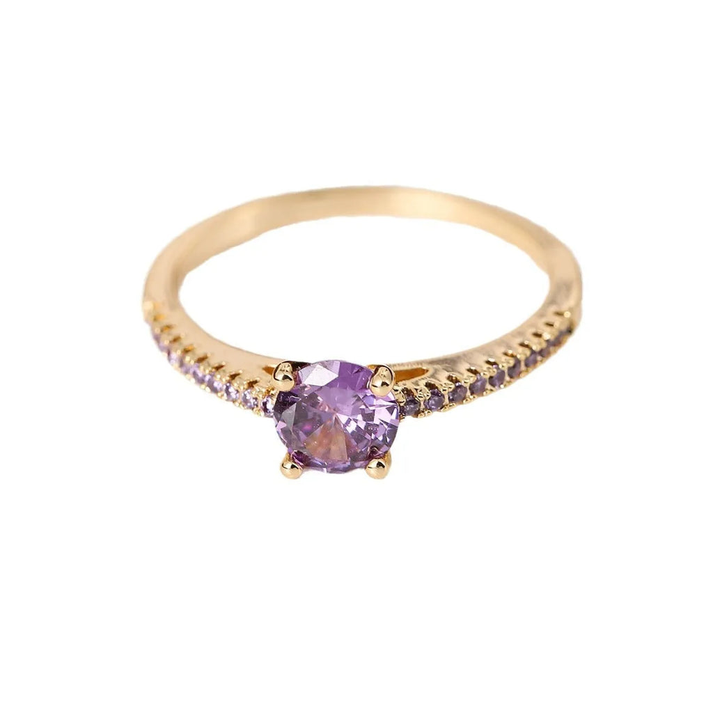 Geometric hexagon design copper zircon ring in various electroplated colours on a size guide.