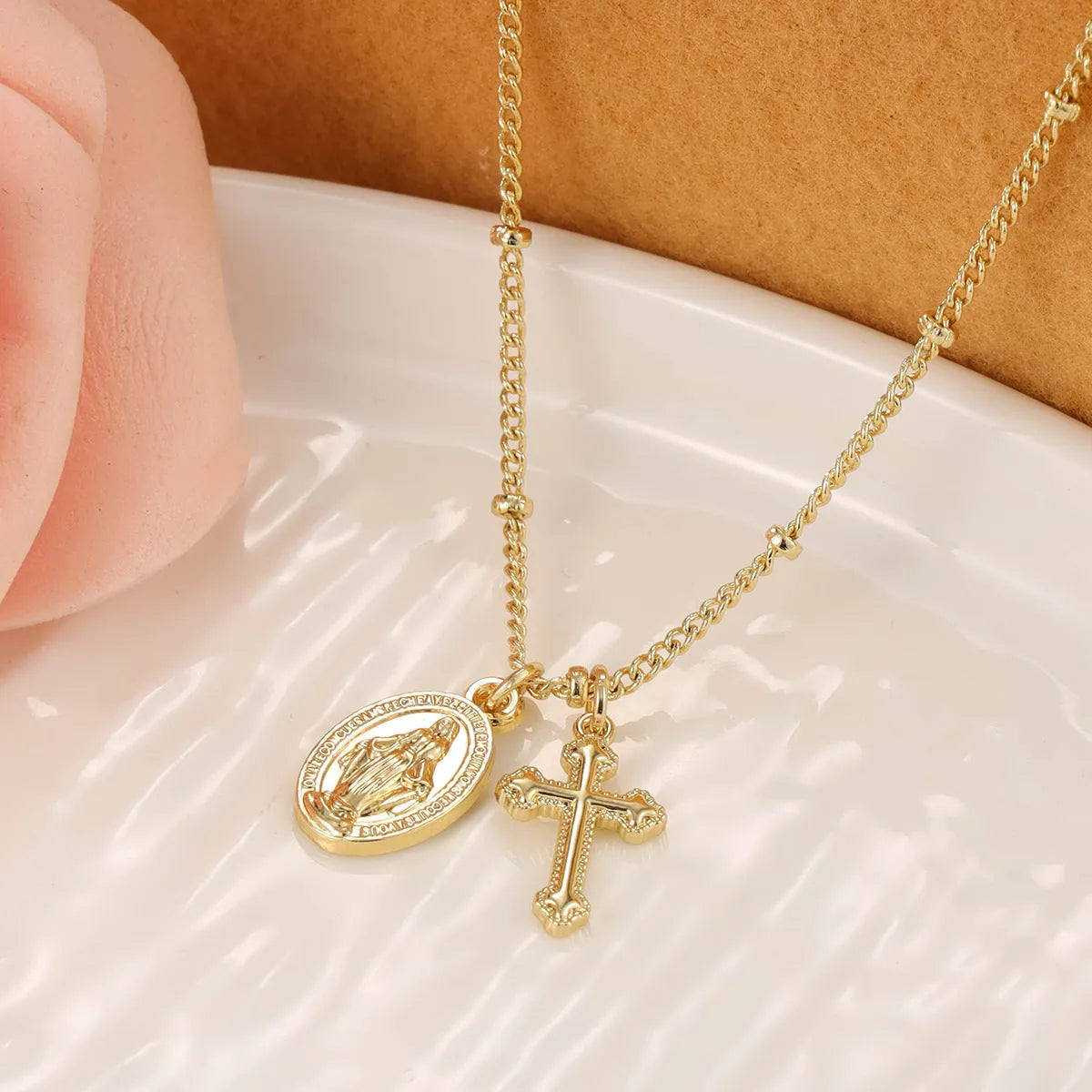 Virgin Mary geometric cross necklace in gold colour with 18k gold-plated copper construction