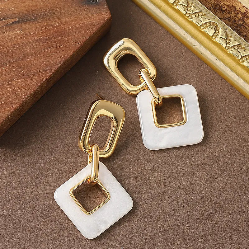 Hollow geometric square earrings in copper with electroplated finish and chamfered corners