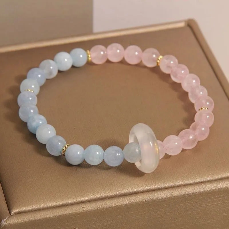 Women's aquamarine crystal bracelet with round geometric beads in mixed materials including natural pink crystal and imitation pearl