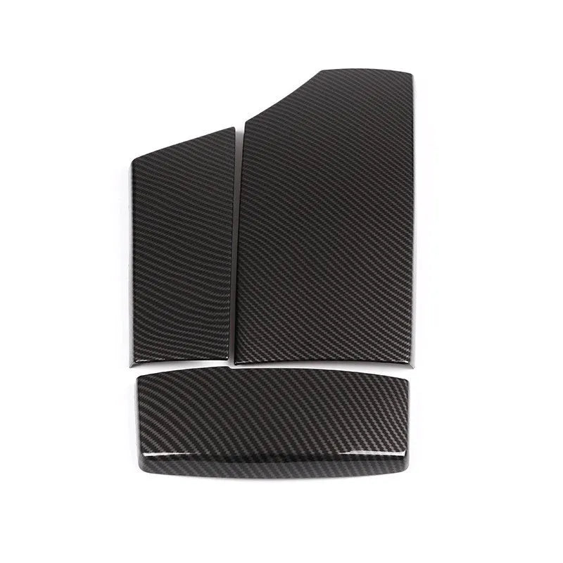 Three black ABS plastic car armrest box covers with a carbon fibre pattern and glossy finish.