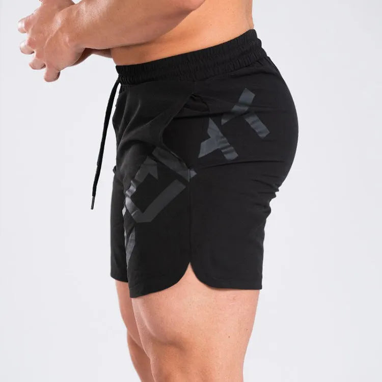 Man wearing black quick-dry nylon sports shorts with an elastic waistband, suitable for running and summer training.
