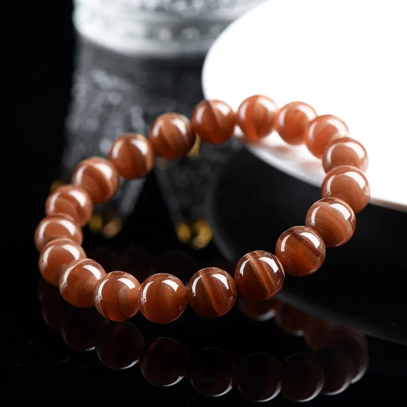 Natural Peruvian rhodochrosite bead bracelet with geometric design and ruyi element