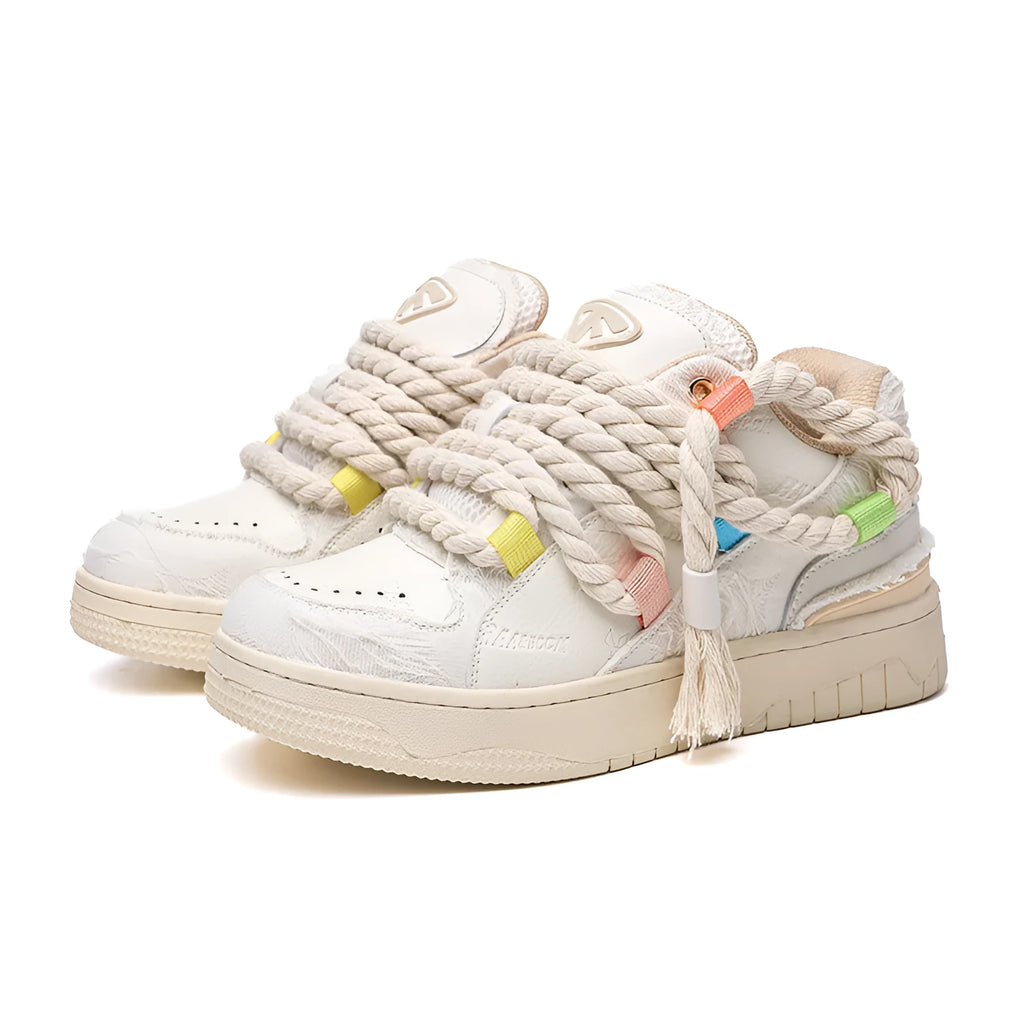 Cream coloured retro lace-up low-top skate shoes on a white background.