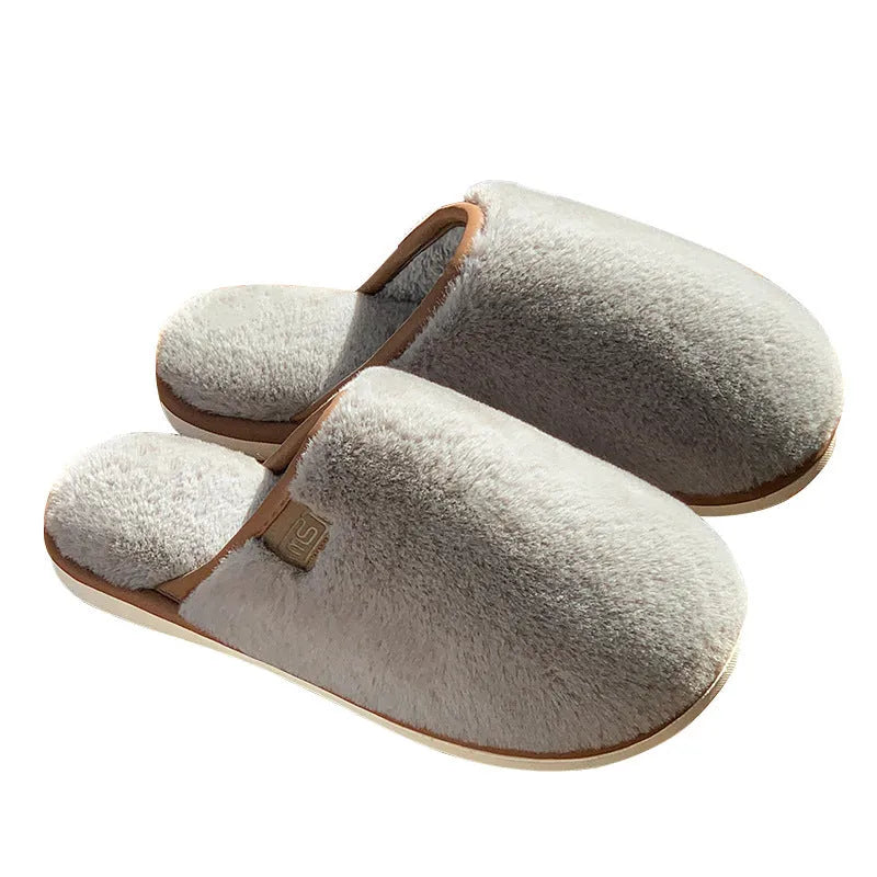 Solid colour PVC plush winter slippers for men and women on a home floor