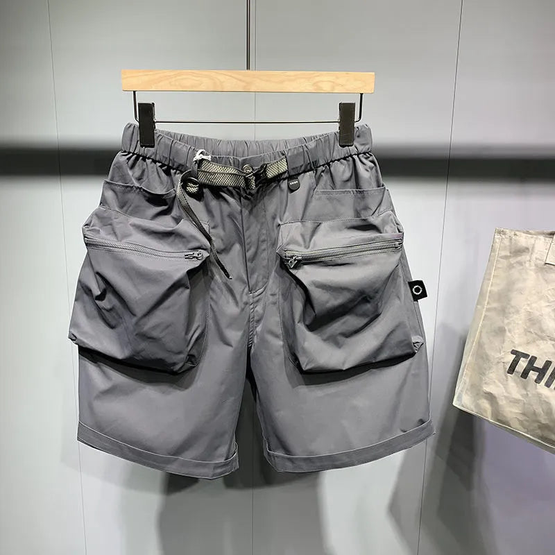 Man wearing large size loose fit black casual shorts with pockets.