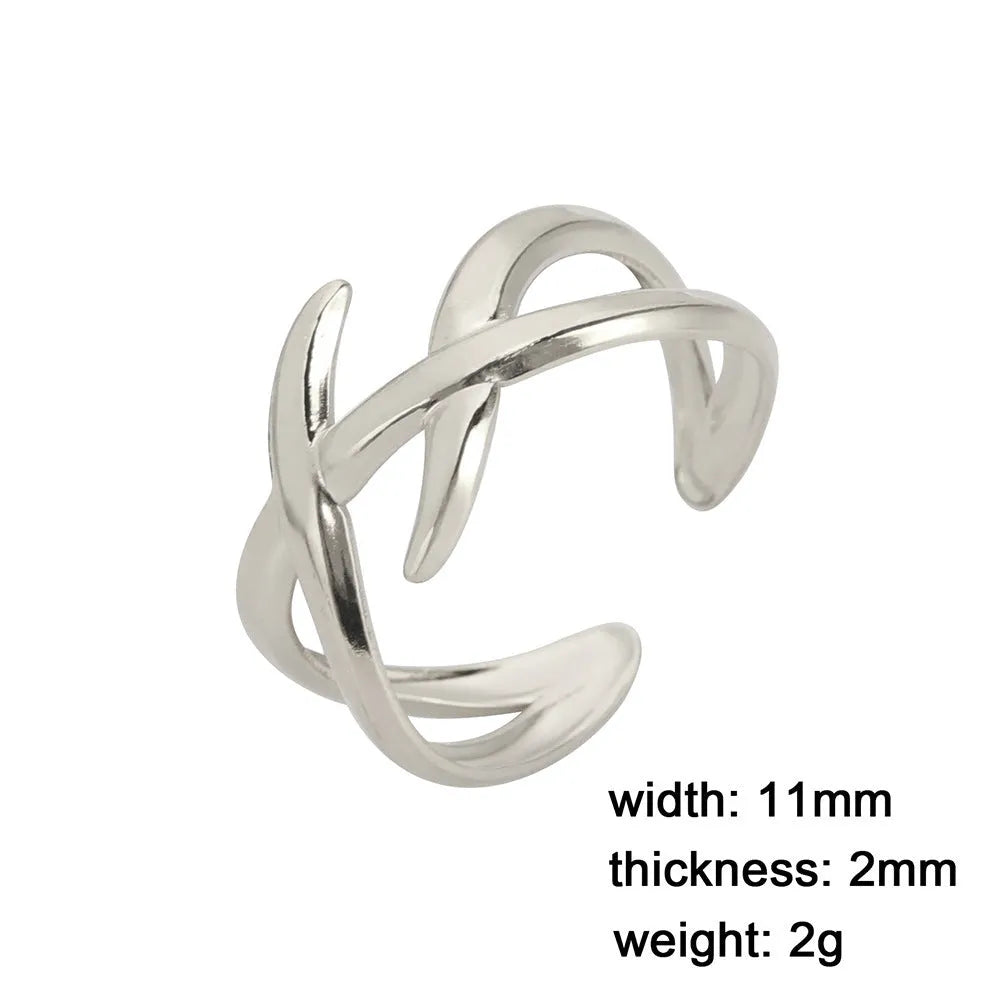 Retro women's stainless steel open ring in gold colour with adjustable opening on white background
