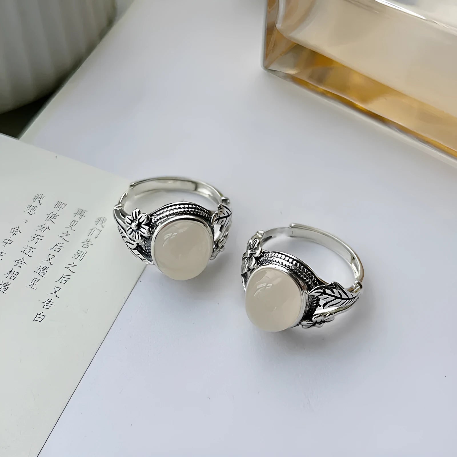 Copper vintage ring with imitation white chalcedony stone and adjustable U-shaped open design.