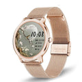 Women's silver smartwatch with stainless steel mesh band and round touch screen on a wrist.