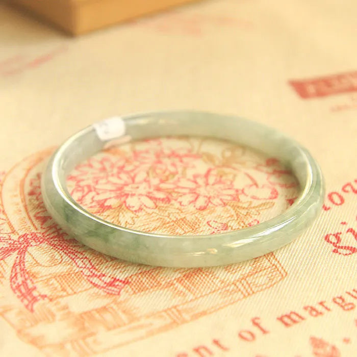 Green waxy jade geometric bracelet on a flat surface, 10mm bead thickness, handcrafted Chinese style