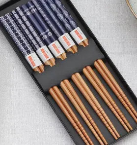 Set of five pairs of bamboo chopsticks with colourful lucky cat cartoon pattern.