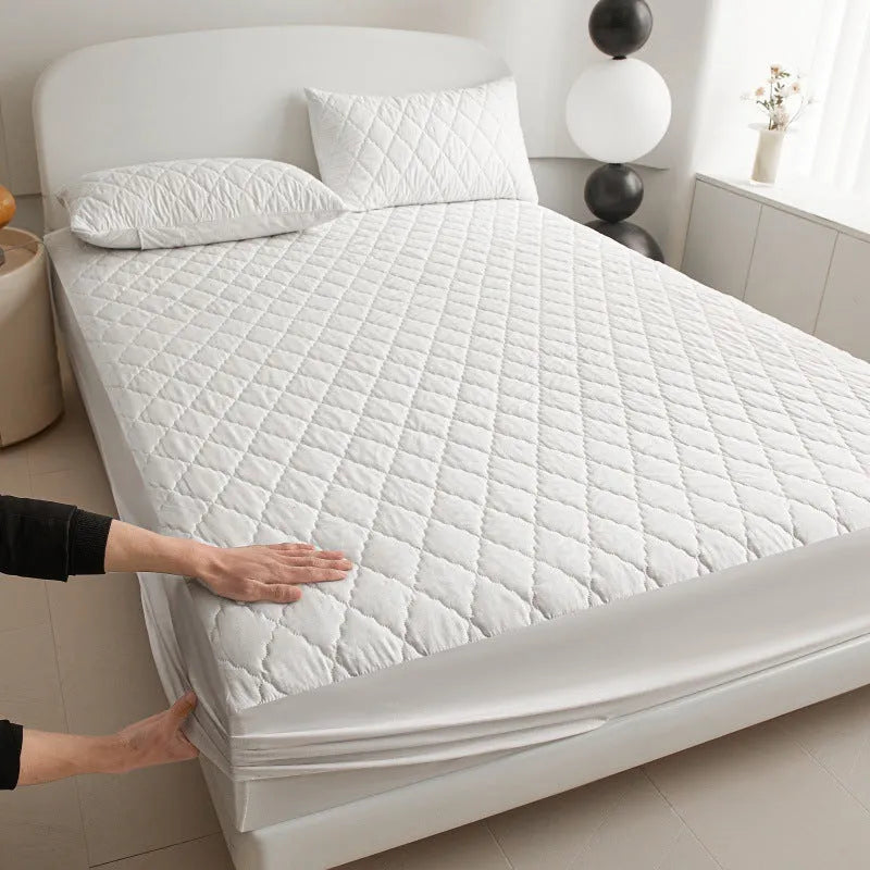 Diamond lattice quilted waterproof mattress protector in bamboo fibre, shown in a solid colour on a bed.