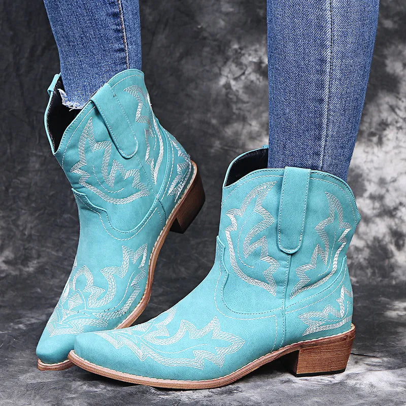 Women's blue embroidered cowboy boots with a low wedge heel and pointed toe.