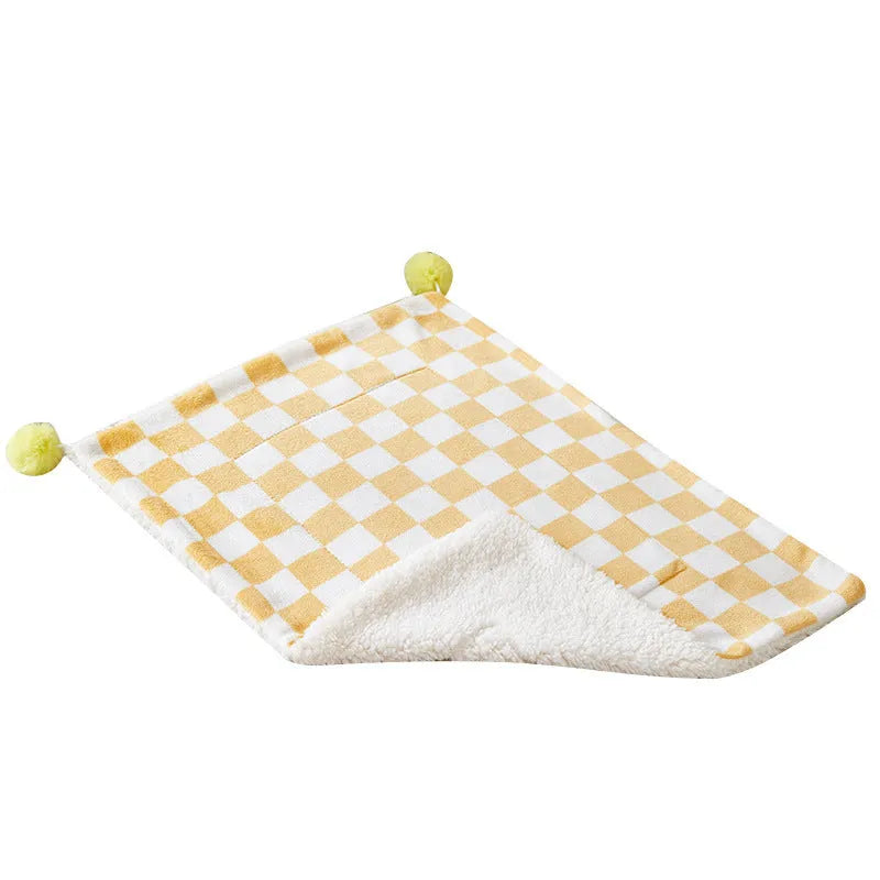 Plush pet blanket with plaid pattern and fur ball decoration for cats and dogs