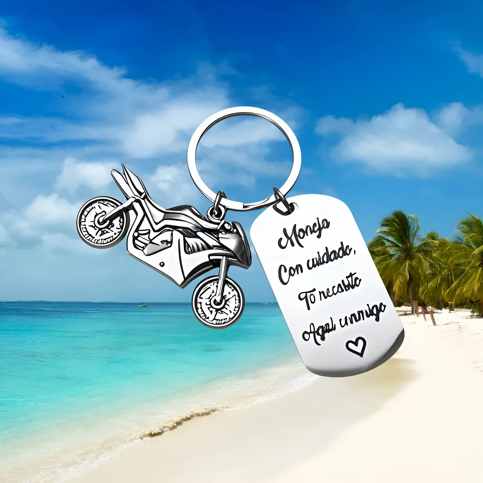 Stainless steel motorcycle-themed keychain with inspirational text alongside a flannel storage pouch.
