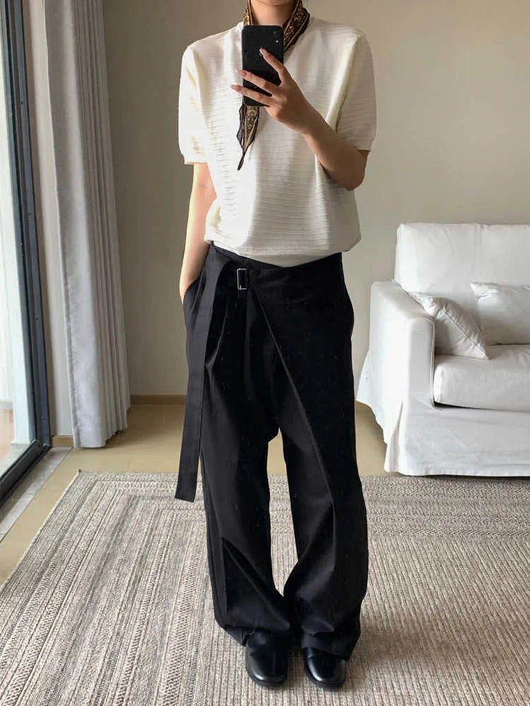 Black straight-leg trousers with single pleat front and adjustable waistband on hanger