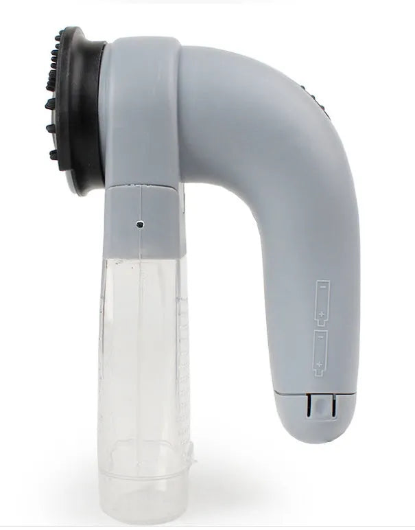 Grey portable electric pet hair remover brush with soft rubber head for grooming dogs and cats.