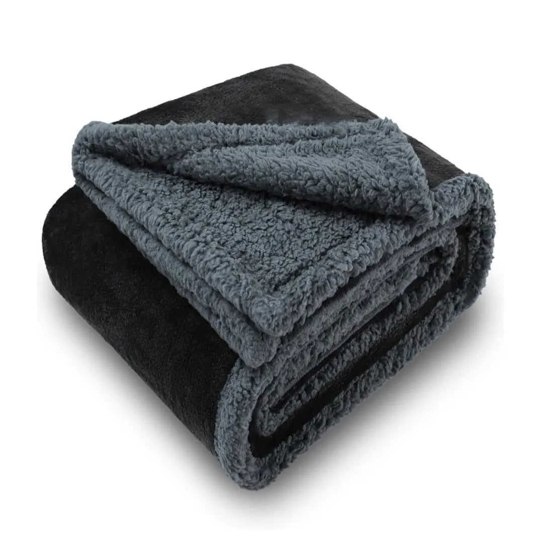 Pet waterproof blanket in beige flannel on a sofa with a dog lying on it