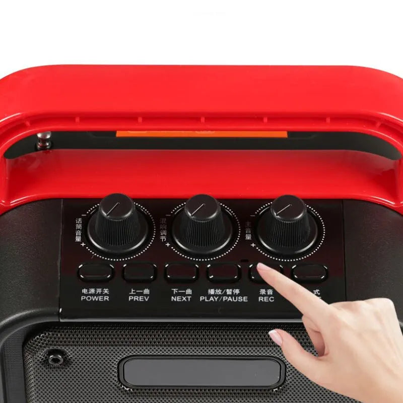 MS62AI portable Bluetooth speaker with wireless microphone on a table showing knob controls.