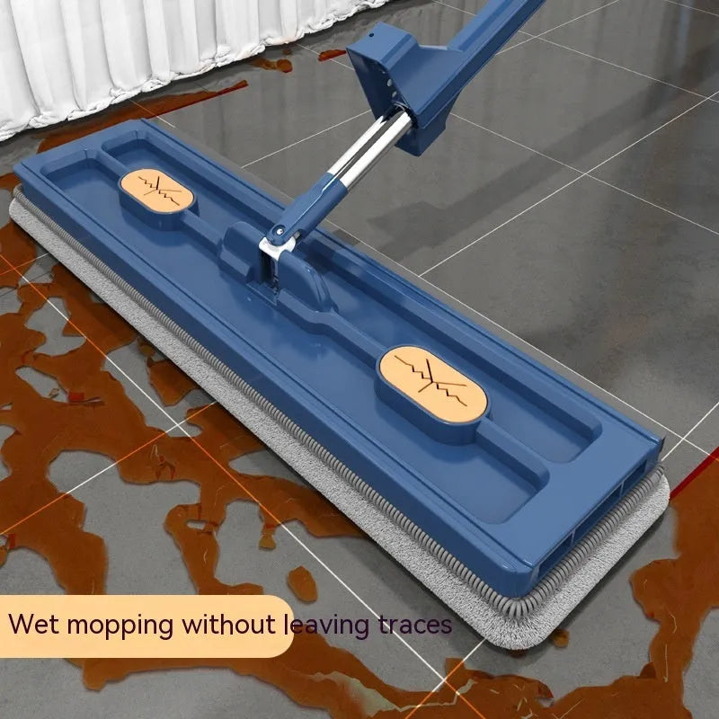 Large flat mop with long stainless steel handle and blue rotating mop head on a wooden floor.