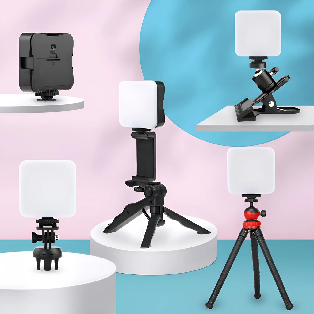 Square-shaped mini LED camera flash with hot shoe mount on a small tripod stand.