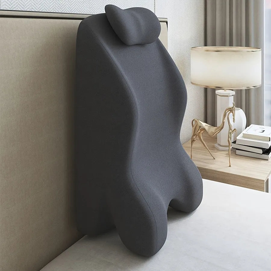 A stomach sleeper pillow shown in light grey, designed for prone positions and reading in bed.