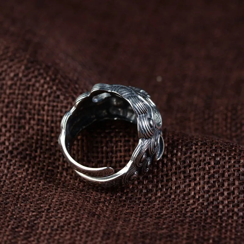 Silver open style ring with detailed jibeast animal pattern and diamond accents