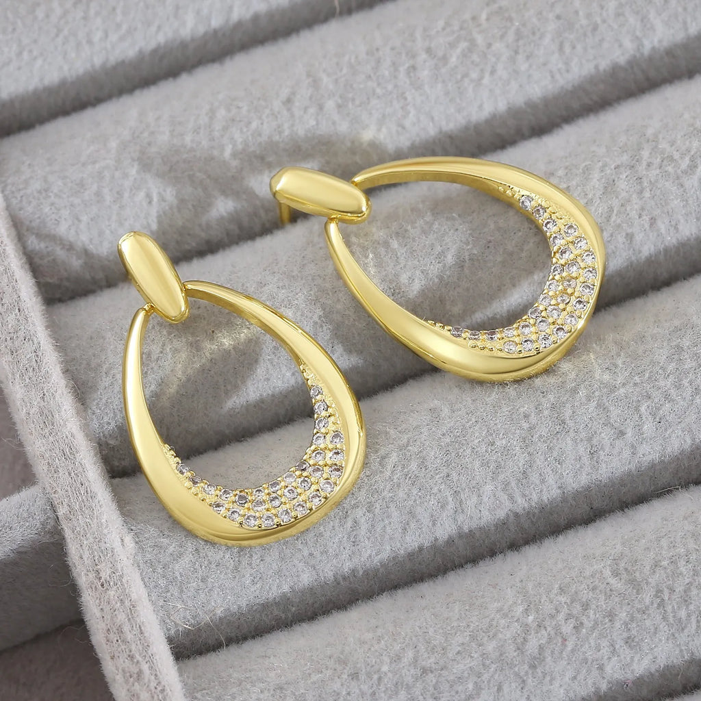 Women's yellow gold geometric drop earrings with oval rings measuring 2.6cm