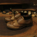 Light brown men's distressed leather casual shoes with lace-up closure and round toe.