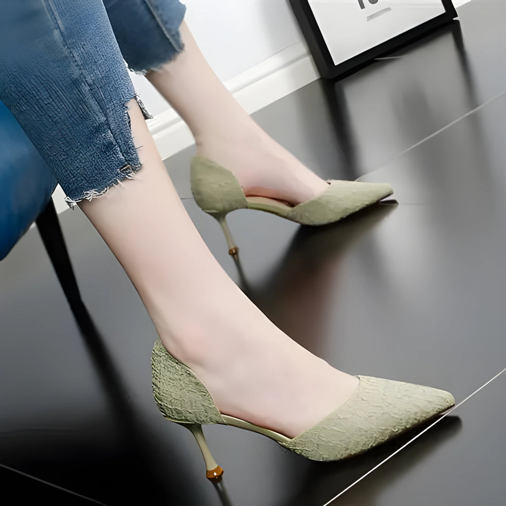 Women's black pointed-toe stiletto high heels with a stitched leather detail and rubber sole.