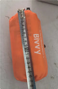 Orange disaster relief tent with sleeping bag and raincoat emergency shelter kit