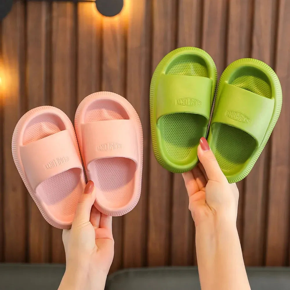 Children's bright coloured EVA slippers with textured non-slip soles on a white background.