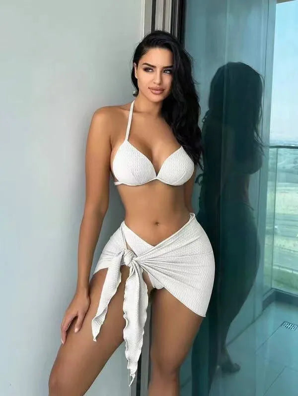 Women's black sexy Russian split three-piece swimsuit set with bikini top, panties, and skirt.