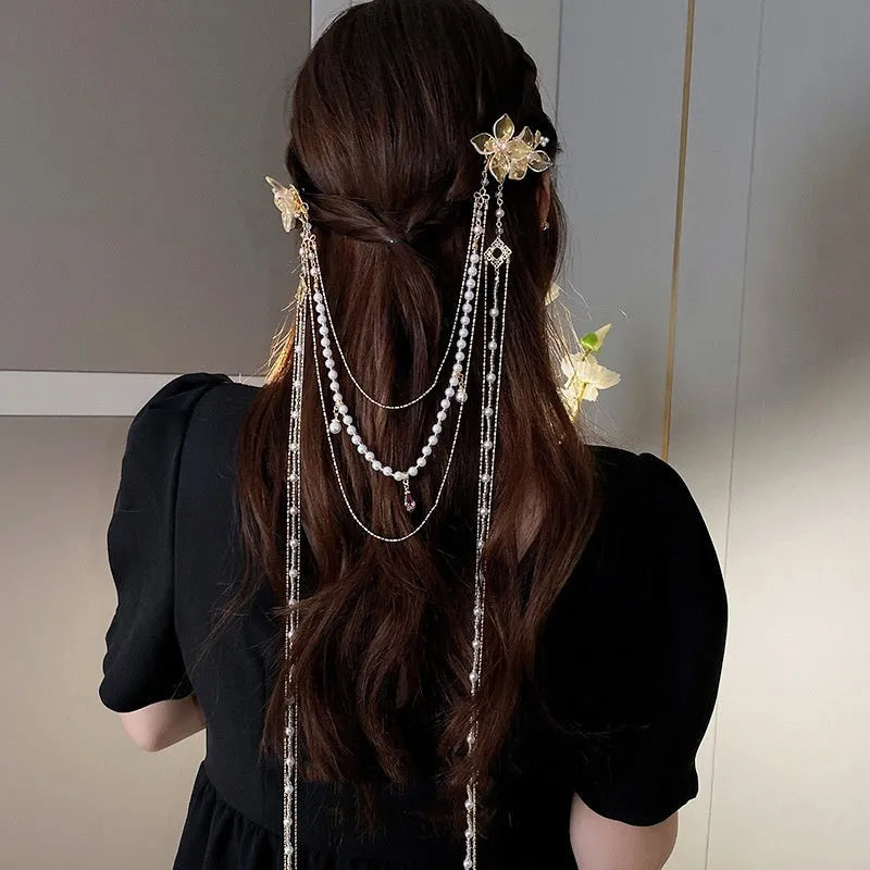 Gold women's hairpin with white pearl and clear diamond floral decoration and a long dangling tassel