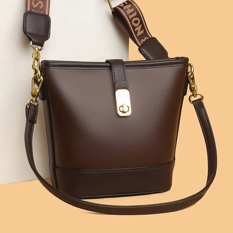 Korean style black bucket messenger bag with double shoulder straps and multiple interior compartments