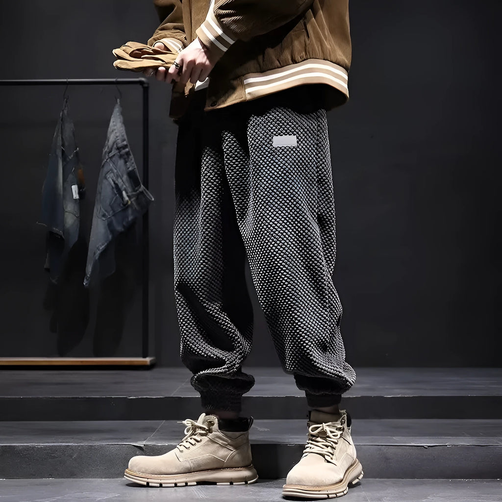 Men's grey straight-leg sweatpants with ankle ties laid flat.