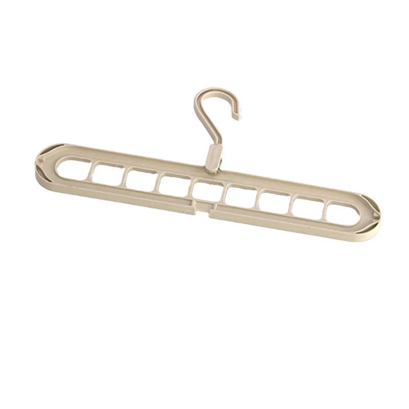 Green nine-hole plastic trouser hanger with folding design for wardrobe organisation