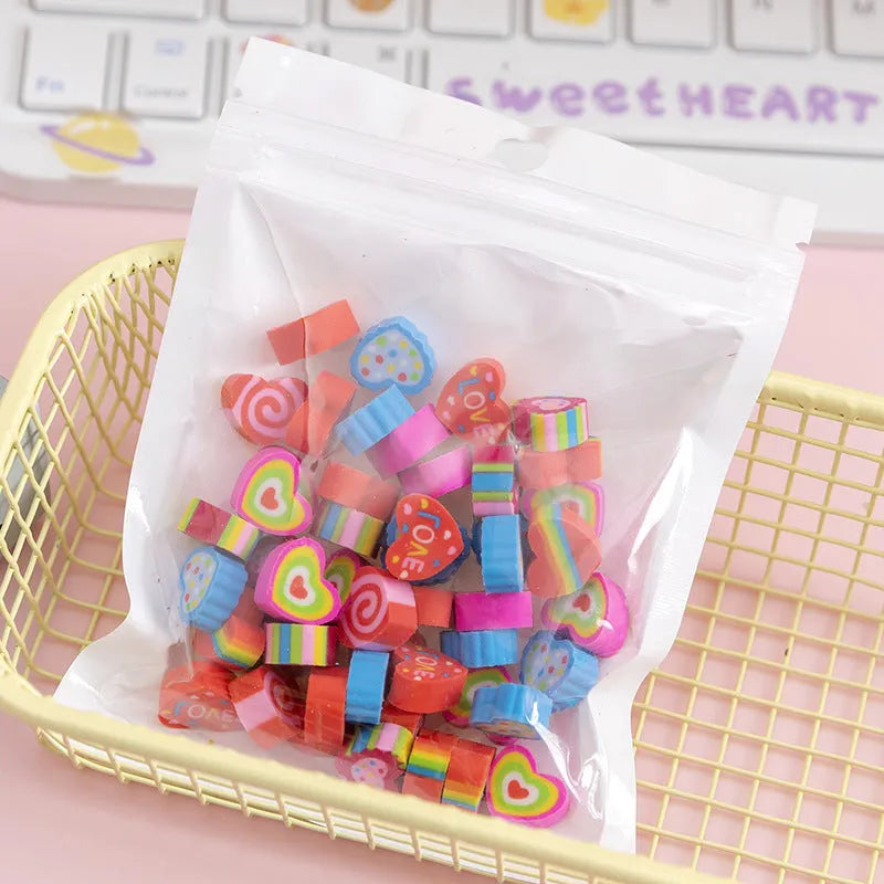 50 small colourful cartoon novelty erasers including fruit and animal shapes in a pearlescent film bag.