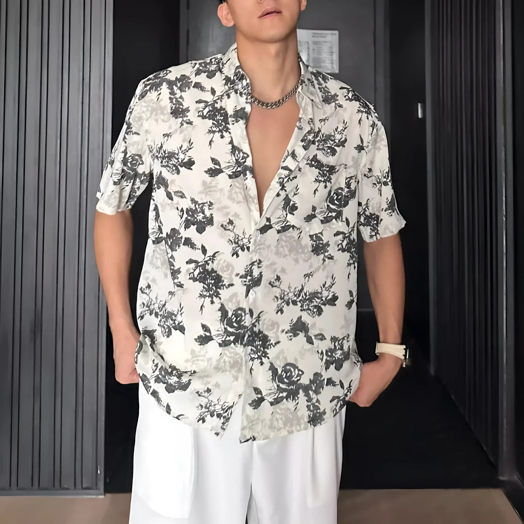 Loose black and white floral print short sleeve casual shirt on a hanger.