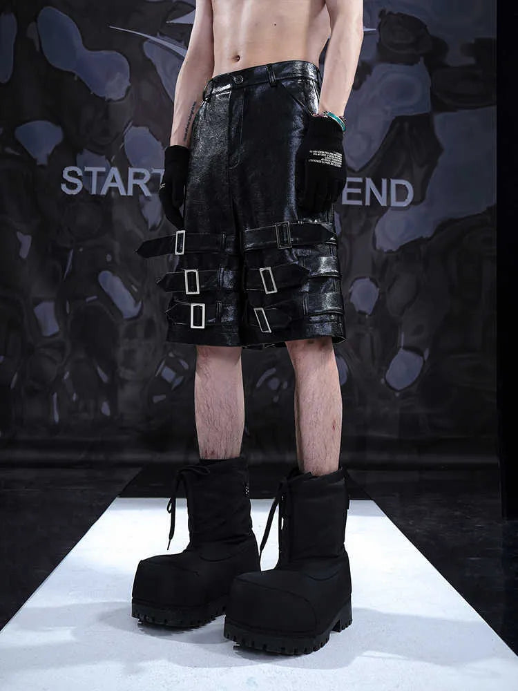 Men's black PU leather cropped shorts with leather ring details on a mannequin.