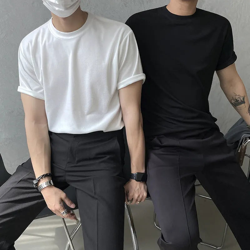 Men's slim fit cotton T-shirt in black on a hanger, showing round neck and regular sleeve.