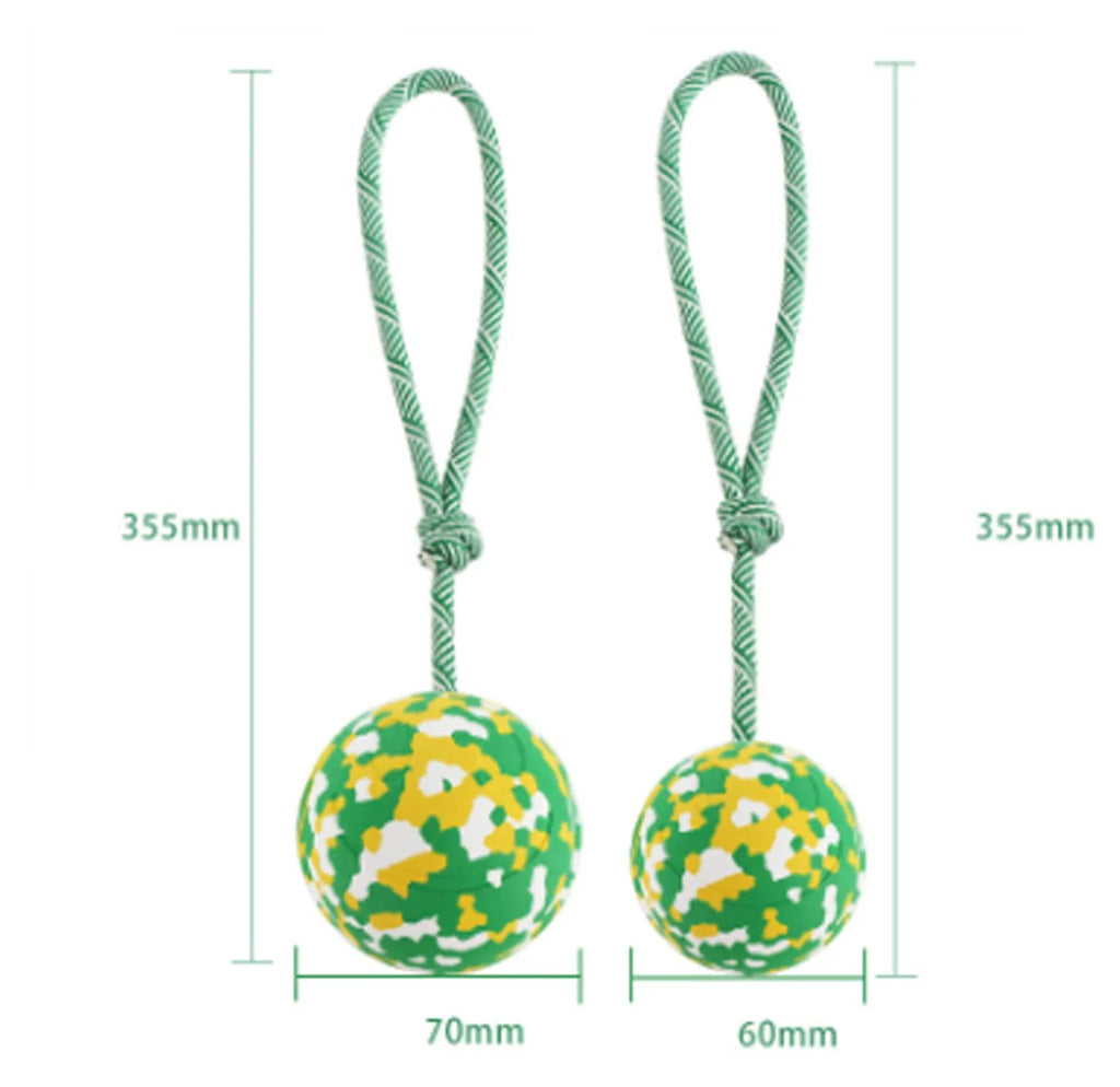 Natural rubber dog ball on a nylon rope toy for interactive fetch and tug games.