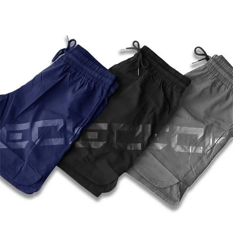 Man wearing black quick-dry nylon sports shorts with an elastic waistband, suitable for running and summer training.
